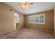 Carpeted primary bedroom with window and ceiling fan at 4223 E Danbury Rd, Phoenix, AZ 85032