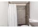 Stylish bathroom with shower featuring stone tile and a modern shower head at 4238 W Krall St, Phoenix, AZ 85019