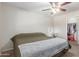 Bedroom features a ceiling fan, carpet flooring, and a walk-in closet at 4238 W Krall St, Phoenix, AZ 85019