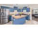 Modern kitchen featuring bold blue cabinets, stainless steel appliances and butcher block countertops and island at 4238 W Krall St, Phoenix, AZ 85019