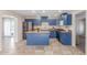 A bright kitchen offers blue cabinets, stainless steel appliances, butcher block countertops, and tile flooring at 4238 W Krall St, Phoenix, AZ 85019
