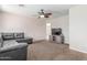 Comfortable living room with neutral paint, ceiling fan and stylish entertainment center at 4238 W Krall St, Phoenix, AZ 85019