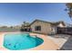 An inviting backyard pool is surrounded by ample patio space and landscaping, perfect for outdoor entertaining at 4238 W Krall St, Phoenix, AZ 85019