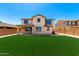 Manicured backyard with a green lawn surrounded by low maintenance landscaping at 4277 N 180Th Ln, Goodyear, AZ 85395
