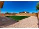 Landscaped backyard features plush green lawn and low maintenance gravel at 4277 N 180Th Ln, Goodyear, AZ 85395