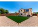 Spacious backyard features green lawn surrounded by low maintenance desert landscaping at 4277 N 180Th Ln, Goodyear, AZ 85395