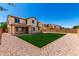 An expansive backyard features a plush green lawn and low maintenance landscaping at 4277 N 180Th Ln, Goodyear, AZ 85395