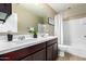 Bathroom with a tub and shower, double vanity and a mirror at 4277 N 180Th Ln, Goodyear, AZ 85395