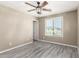 Cozy bedroom with ceiling fan, window for natural light and neutral walls over wood-look floors provides a serene retreat at 4277 N 180Th Ln, Goodyear, AZ 85395