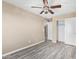 A bedroom with gray wood floors, ceiling fan, and a closet at 4277 N 180Th Ln, Goodyear, AZ 85395
