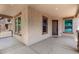 Inviting covered porch features a neutral color palette with a view to the house next door at 4277 N 180Th Ln, Goodyear, AZ 85395