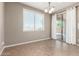 An open dining room with a sliding glass door and a large window, providing ample natural light at 4277 N 180Th Ln, Goodyear, AZ 85395