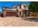 Two-story home featuring stucco siding, a covered porch, paver driveway, and a two-car garage at 4277 N 180Th Ln, Goodyear, AZ 85395