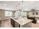 An open kitchen flows into a living area, creating an inviting space for entertaining and Gathering gatherings at 4277 N 180Th Ln, Goodyear, AZ 85395