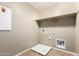 Bright laundry room features built in shelf, washer, and dryer hookups ready for your appliances at 4277 N 180Th Ln, Goodyear, AZ 85395