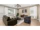 Comfortable living room features tile floors, a large window, modern decor, and a ceiling fan at 4277 N 180Th Ln, Goodyear, AZ 85395