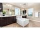 Luxurious main bathroom with dual vanities, soaking tub, and large windows for a spa-like retreat at home at 4277 N 180Th Ln, Goodyear, AZ 85395