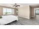 Inviting main bedroom filled with natural light with neutral color palette, wood-look floors and an ensuite bathroom at 4277 N 180Th Ln, Goodyear, AZ 85395