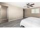 Bright main bedroom with ensuite access, ceiling fan, neutral walls and wood-look flooring for a calming, inviting space at 4277 N 180Th Ln, Goodyear, AZ 85395