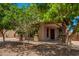 A covered front porch with wood columns with stone detail and paver driveway at 4277 N 180Th Ln, Goodyear, AZ 85395