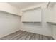 Spacious walk-in closet providing generous storage space with shelving and hanging rods for organized wardrobe management at 4277 N 180Th Ln, Goodyear, AZ 85395