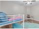 Bedroom with a bunkbed and desk, showcasing hardwood floors and a comfortable and functional layout at 44853 W Jack Rabbit Trl, Maricopa, AZ 85139