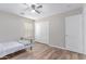 This bedroom features wood-look floors and a ceiling fan with white trim and ample closet space at 44853 W Jack Rabbit Trl, Maricopa, AZ 85139