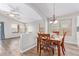 Dining room with hardwood floors, natural light, and an open layout to the living spaces at 44853 W Jack Rabbit Trl, Maricopa, AZ 85139
