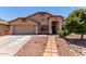 Single-story home boasts well-maintained landscaping, a two-car garage, and excellent curb appeal at 44853 W Jack Rabbit Trl, Maricopa, AZ 85139