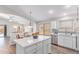 Bright kitchen features an island, stainless steel appliances, and backyard views at 44853 W Jack Rabbit Trl, Maricopa, AZ 85139