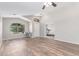 Spacious living area with archway and backyard views, offering versatile space for work or relaxation at 44853 W Jack Rabbit Trl, Maricopa, AZ 85139