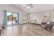 Bright living room boasts hardwood flooring, access to the pool, and comfortable seating at 44853 W Jack Rabbit Trl, Maricopa, AZ 85139