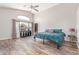 Bright main bedroom boasts wood-look floors and lots of natural light at 44853 W Jack Rabbit Trl, Maricopa, AZ 85139