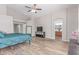 Spacious main bedroom features wood-look floors, with a ceiling fan, and ensuite bathroom at 44853 W Jack Rabbit Trl, Maricopa, AZ 85139