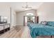 Light-filled main bedroom boasts wood-look floors and a high ceiling at 44853 W Jack Rabbit Trl, Maricopa, AZ 85139