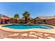 Backyard pool with rock waterfall, landscaping, and hardscape at 44853 W Jack Rabbit Trl, Maricopa, AZ 85139