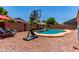 Backyard with inground pool, basketball hoop, and patio furniture for outdoor entertaining at 44853 W Jack Rabbit Trl, Maricopa, AZ 85139