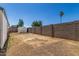 The backyard features privacy wall, landscaping, shed and blue skies at 4526 W Mission Ln, Glendale, AZ 85302