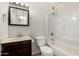 Bathroom featuring vanity, mirror, medicine cabinet, lighting, toilet and tiled shower and tub at 4526 W Mission Ln, Glendale, AZ 85302
