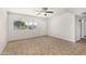 Inviting bedroom with a ceiling fan, tile flooring, and a sunny window at 4526 W Mission Ln, Glendale, AZ 85302