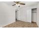 Bedroom with a ceiling fan, tile flooring, and a closet for ample storage at 4526 W Mission Ln, Glendale, AZ 85302