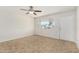 Bright bedroom featuring tile floors, a ceiling fan, and large windows for ample light at 4526 W Mission Ln, Glendale, AZ 85302
