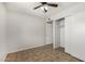 Bedroom featuring tile flooring, ceiling fan, and closet space at 4526 W Mission Ln, Glendale, AZ 85302