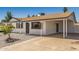 Cozy house with a large carport, low-maintenance yard, and white brick exterior at 4526 W Mission Ln, Glendale, AZ 85302
