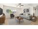 Bright living room with neutral tones, a ceiling fan, a large window, and stylish decor at 4526 W Mission Ln, Glendale, AZ 85302