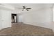 Bright living area boasting tile floors, a ceiling fan, and an open view to the modern kitchen at 4526 W Mission Ln, Glendale, AZ 85302