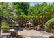 Charming backyard garden with a stone patio, water feature, benches, and lush landscaping creating a peaceful retreat at 4528 E Donato Dr, Gilbert, AZ 85298
