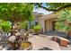 Backyard featuring beautiful lush landscaping and a peaceful water feature sitting area at 4528 E Donato Dr, Gilbert, AZ 85298
