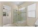 Bathroom showcasing glass shower with bench and tile surround, offering comfortable bathing experience at 4528 E Donato Dr, Gilbert, AZ 85298