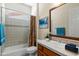 Bathroom showcasing single vanity, shower-tub combo, and charming decor for added convenience and style at 4528 E Donato Dr, Gilbert, AZ 85298